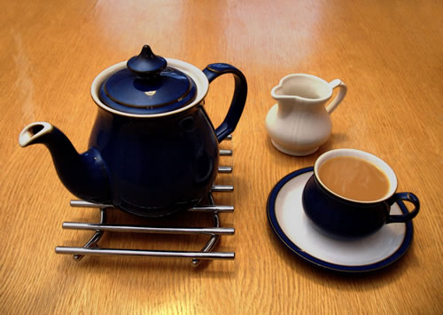 Teapot next to cup and saucer